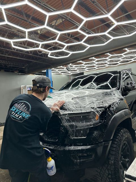 A car is being washed with foam in a garage.