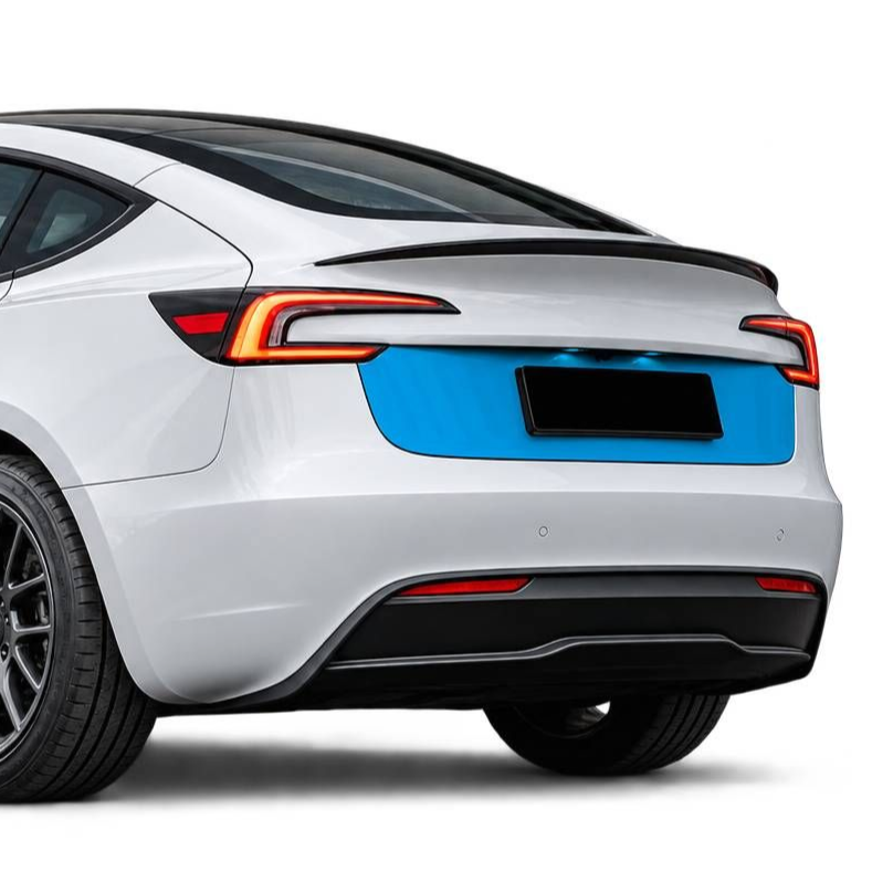 Rear three-quarter view of a silver electric sports sedan with black accents and blue rear panel on a white background
