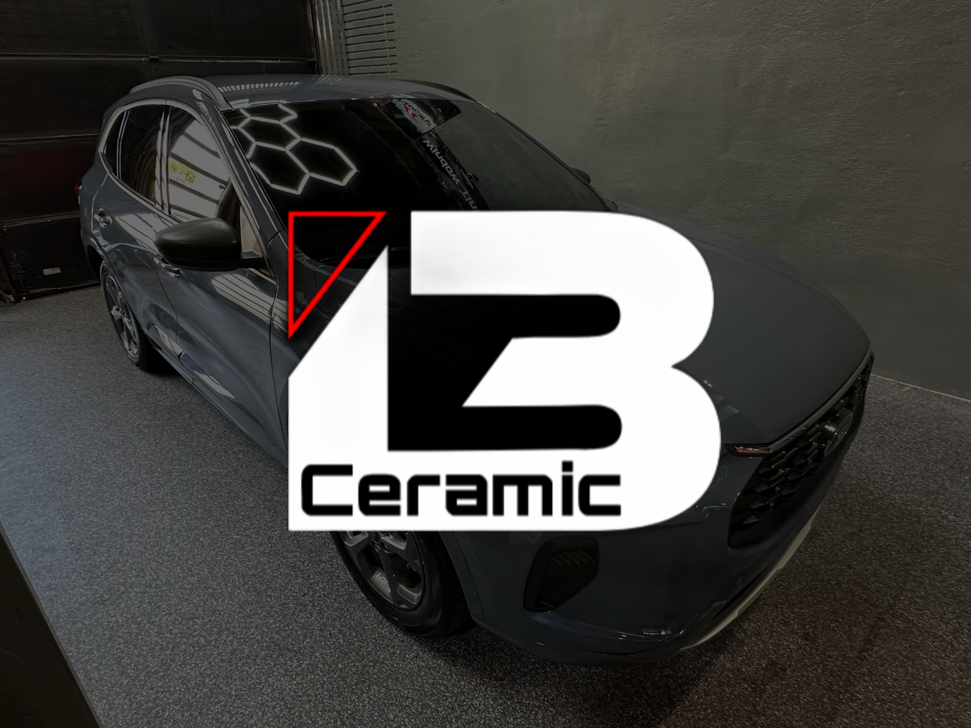Dark gray car in a garage with a large “LB Ceramic” logo overlayed