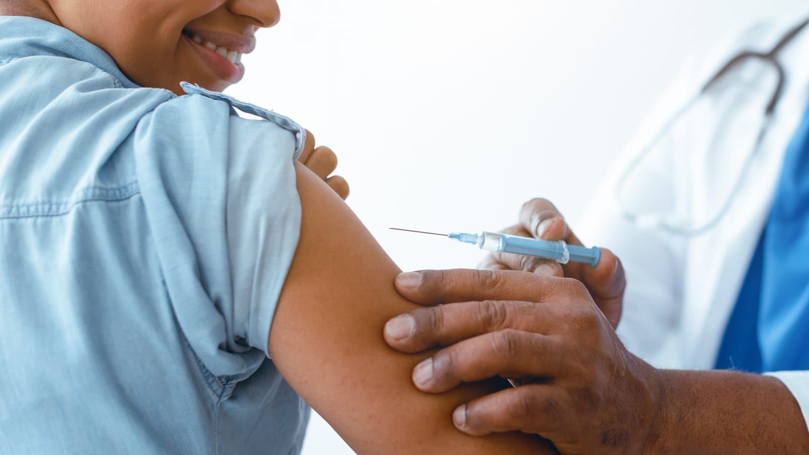 Health worker giving a peptide injection in a patient’s upper arm at a NYC clinic