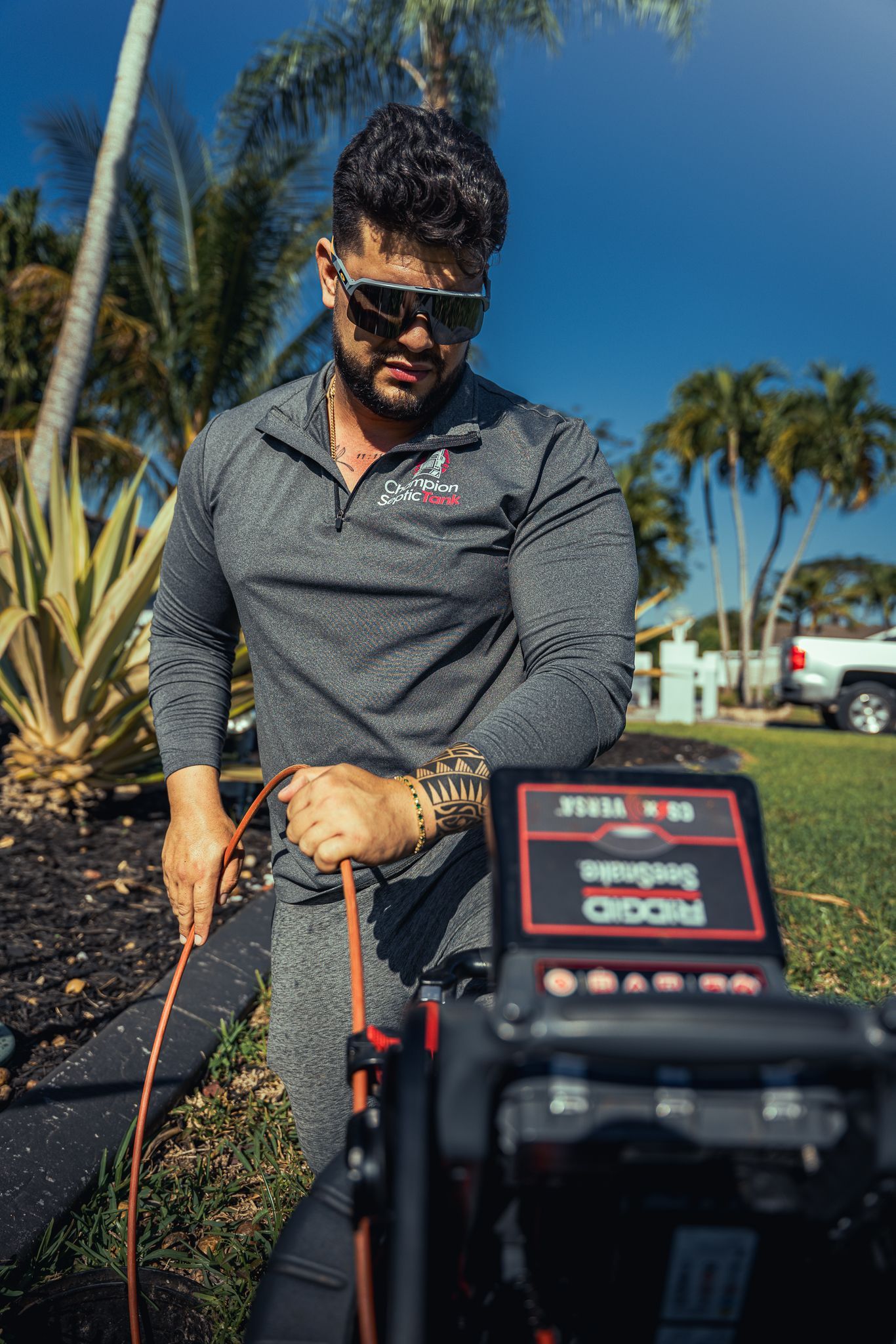 A man is standing next to a machine in a garden.