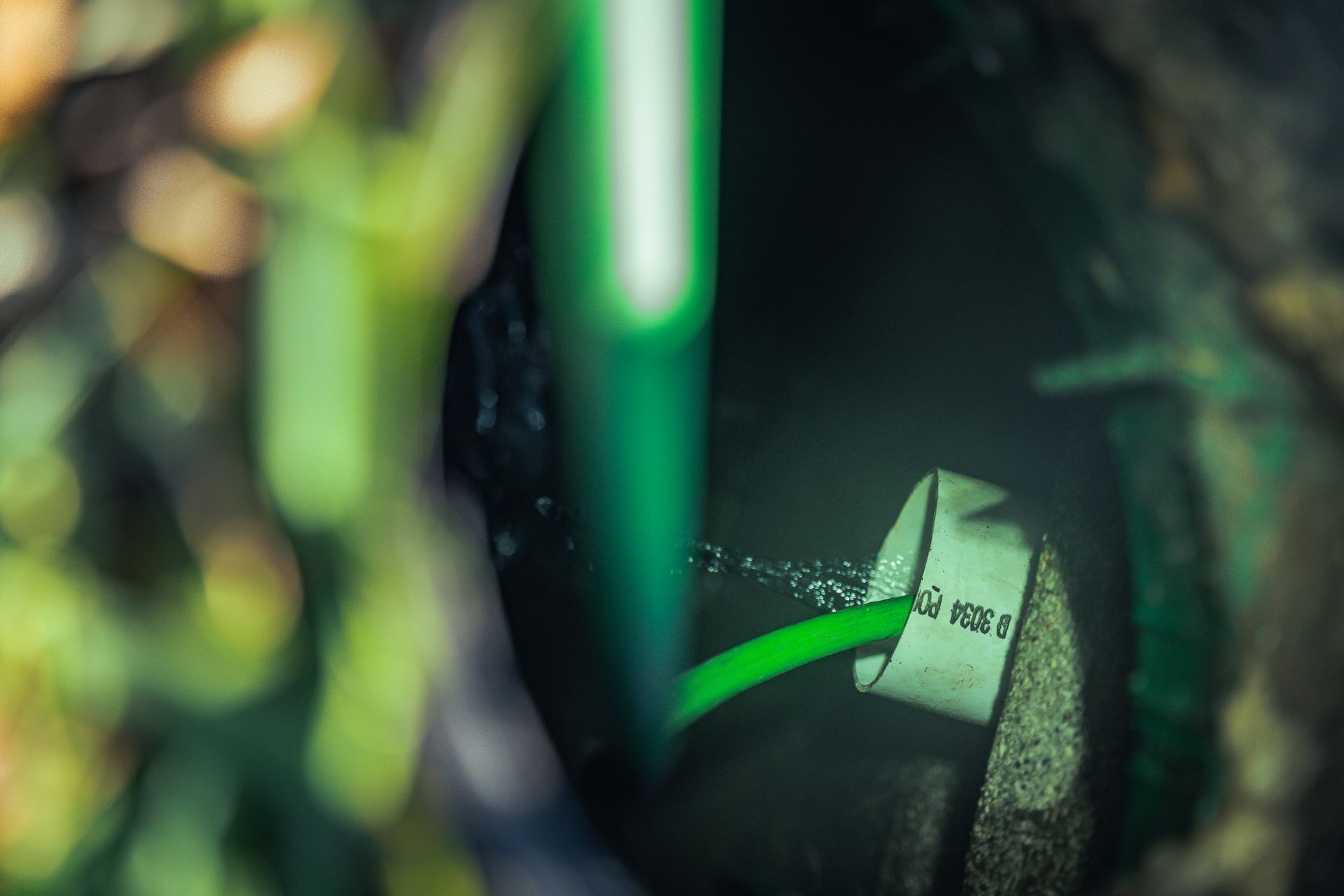 A close up of a green object with a green light coming out of it.