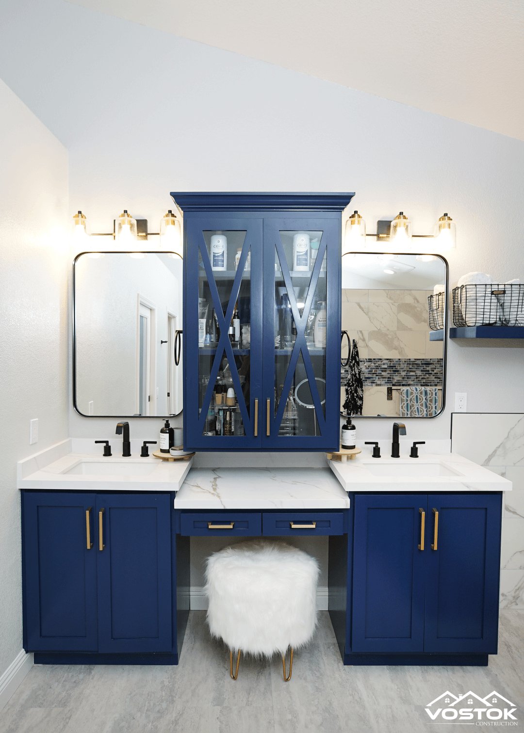 A bathroom with two sinks , a vanity , and a mirror.