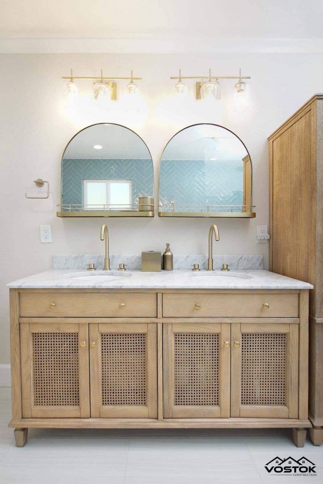A bathroom with two sinks and two mirrors.