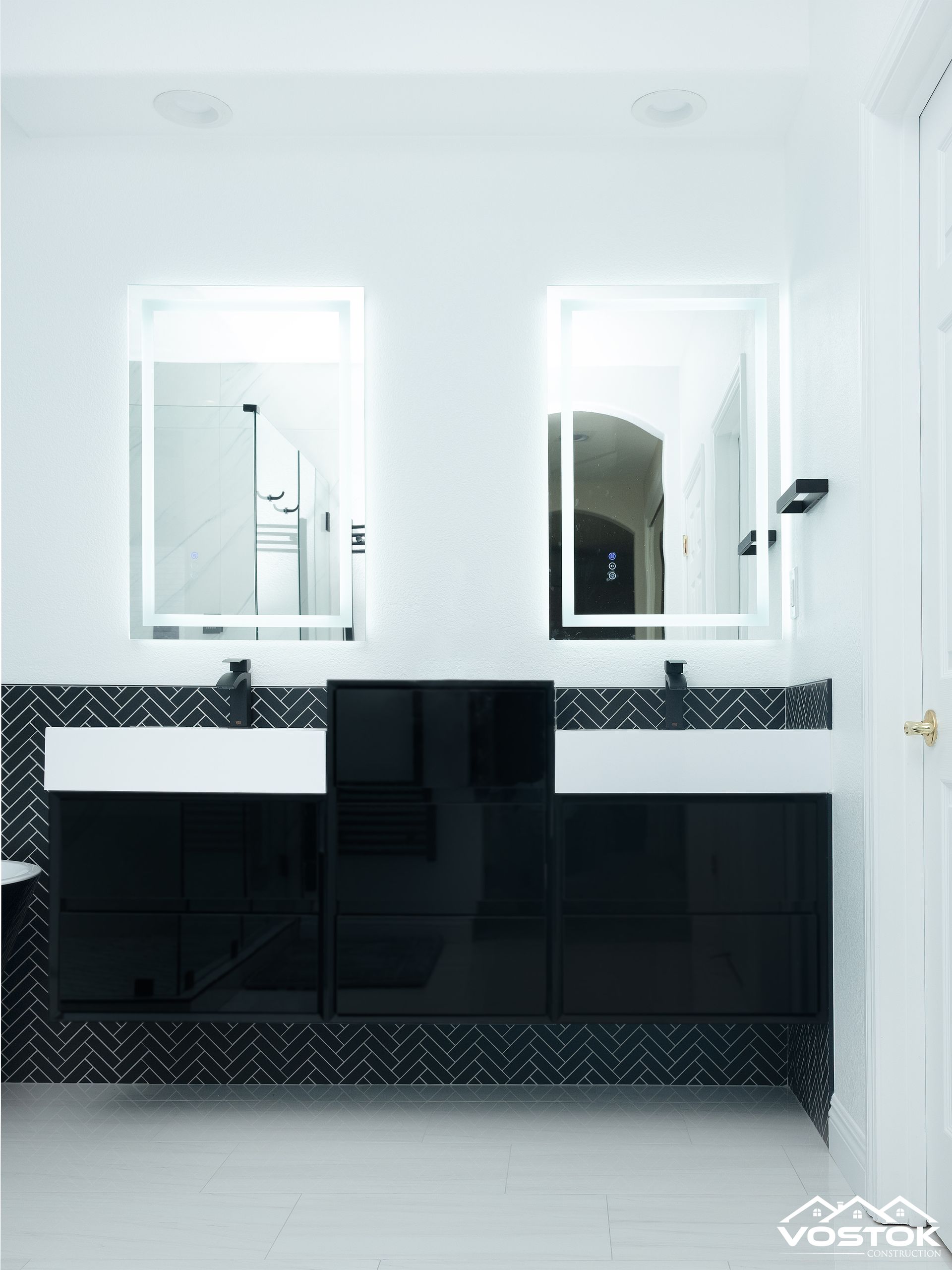 A bathroom with two sinks and two mirrors.