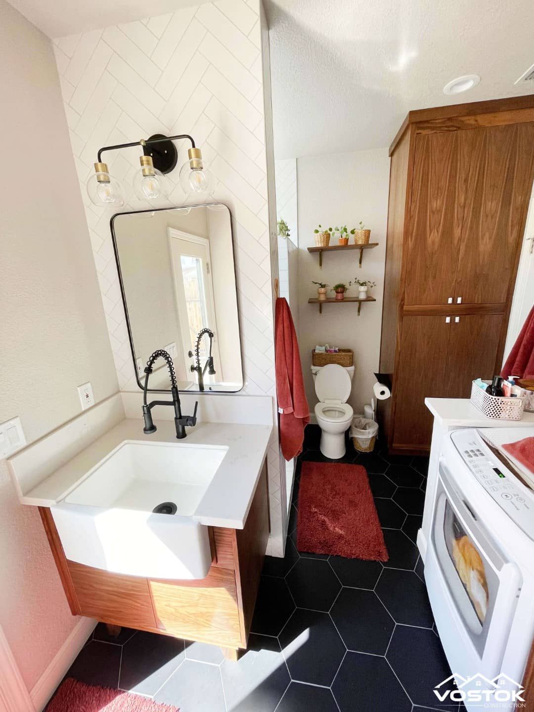 A bathroom with a sink , toilet , and mirror.