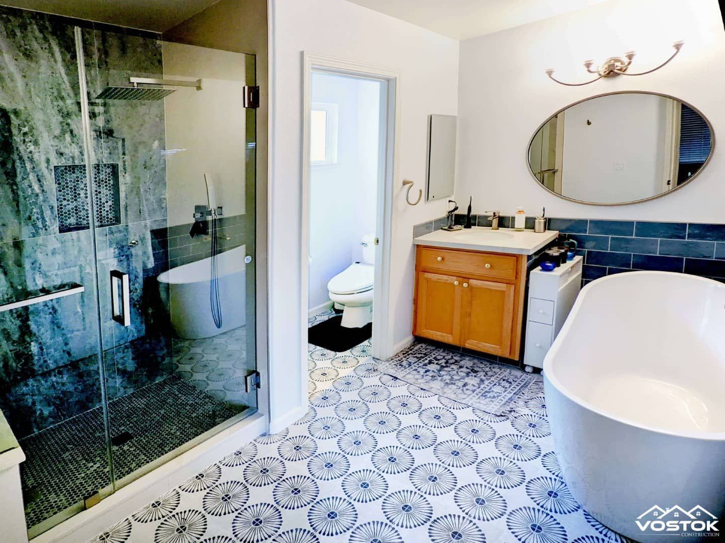 A bathroom with a tub , sink , toilet and shower.