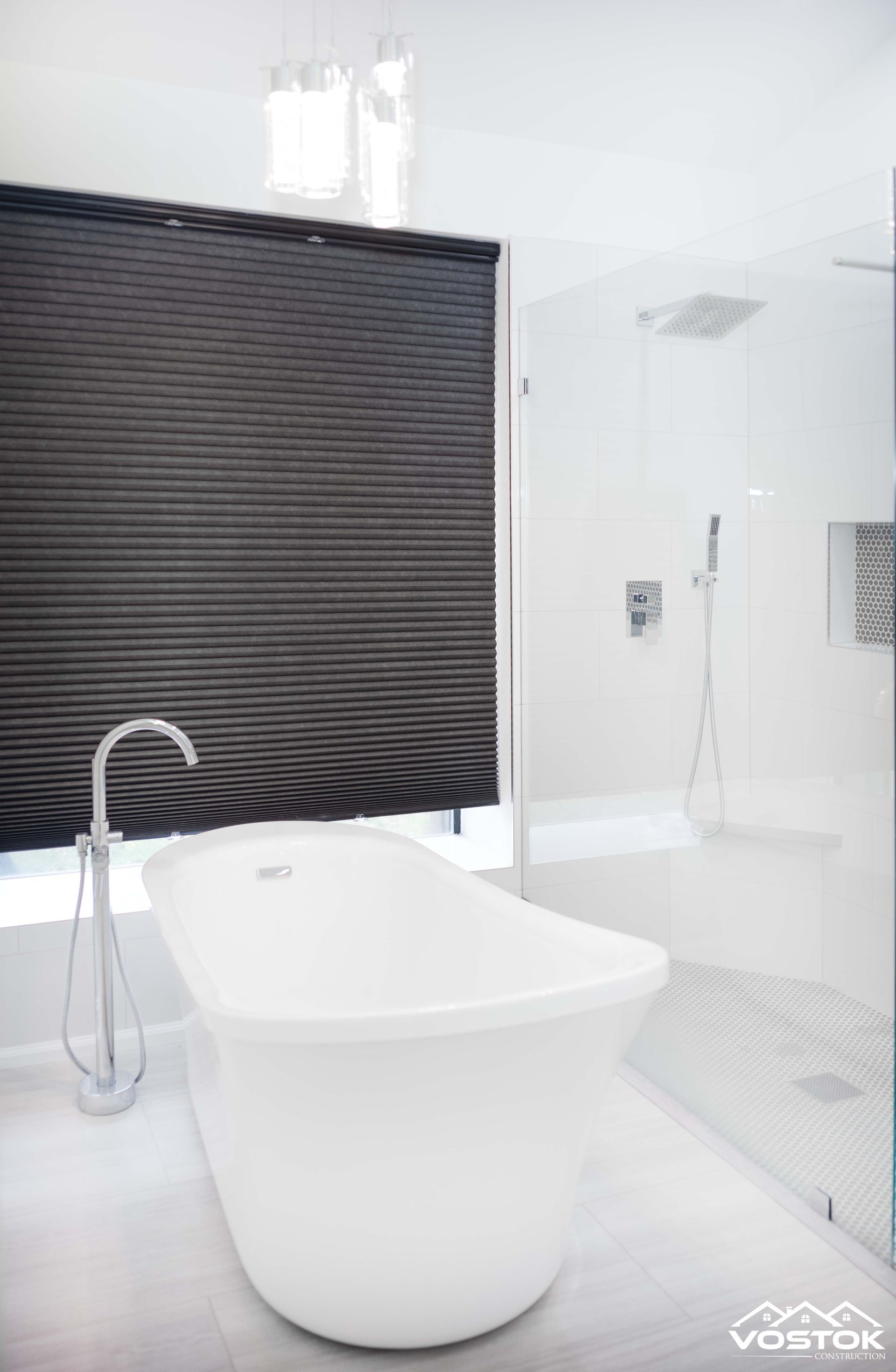 A bathroom with a bathtub and a shower.