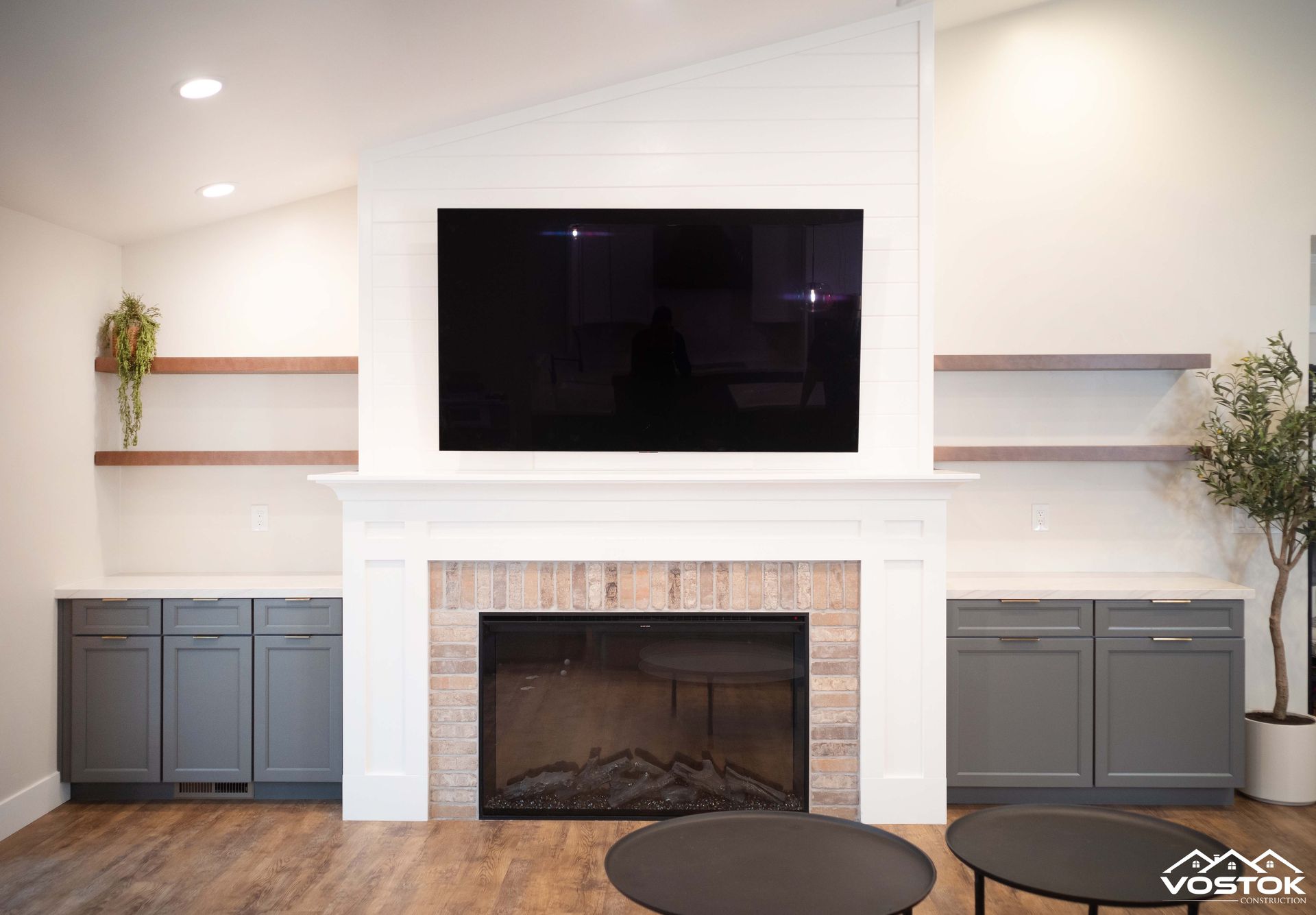 A living room with a fireplace and a flat screen tv.
