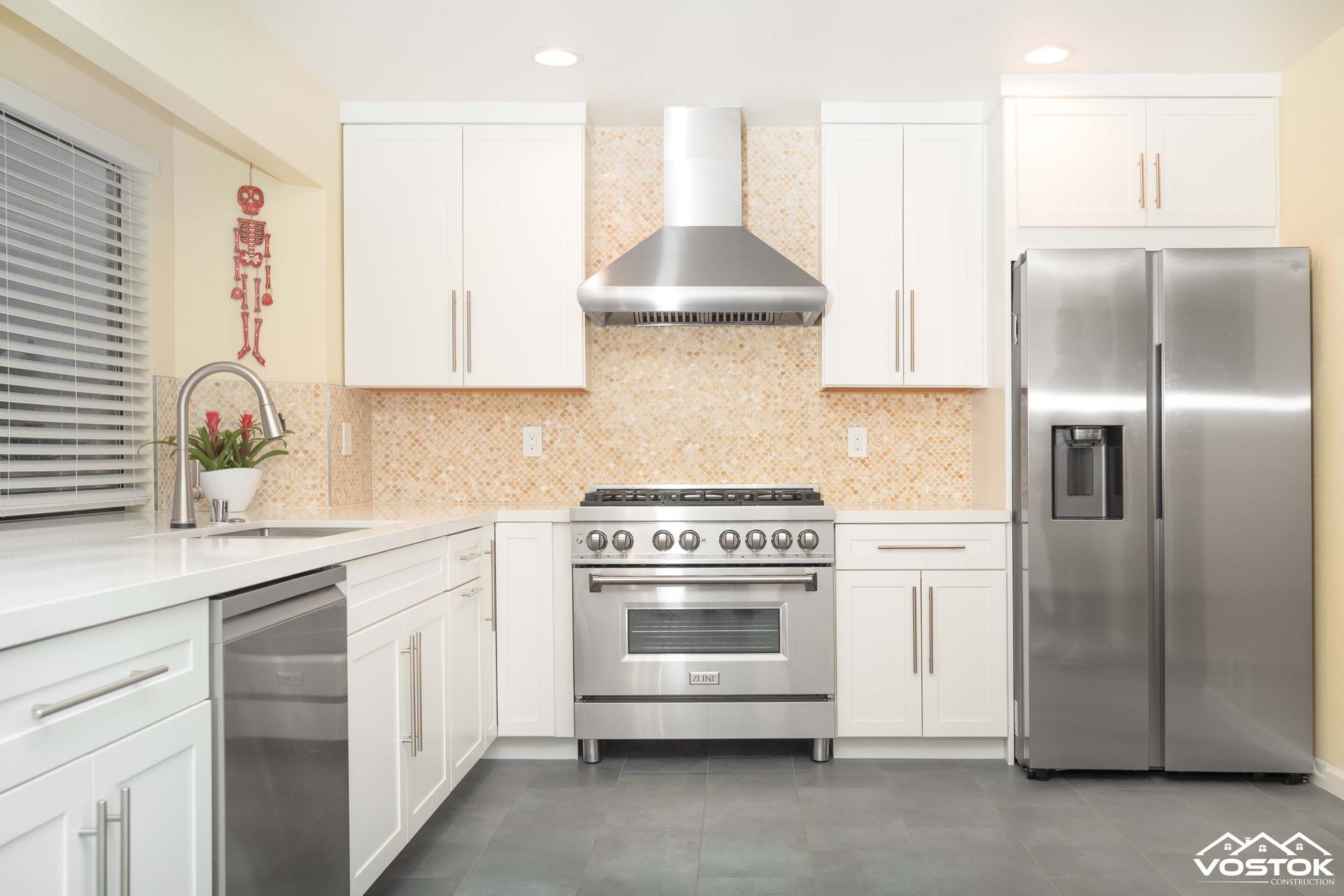 A kitchen with stainless steel appliances and white cabinets