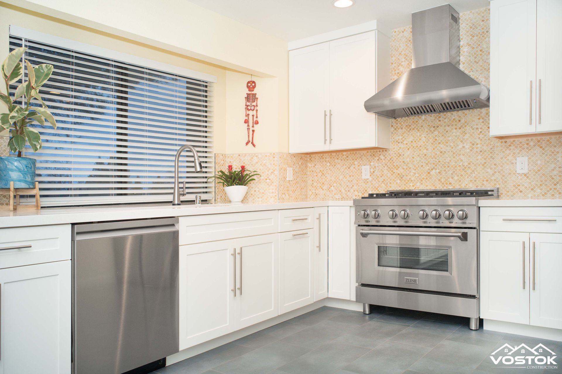 A kitchen with stainless steel appliances and white cabinets