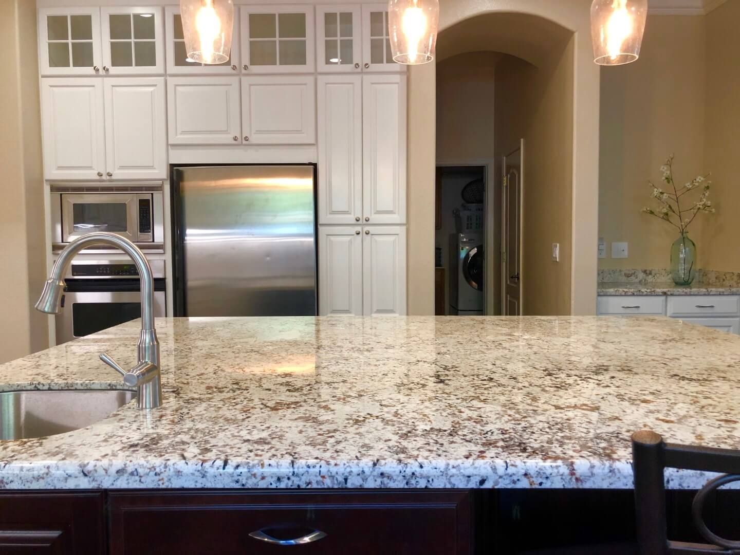 A kitchen with granite counter tops and stainless steel appliances