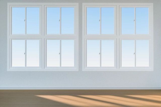 A row of white windows in an empty room