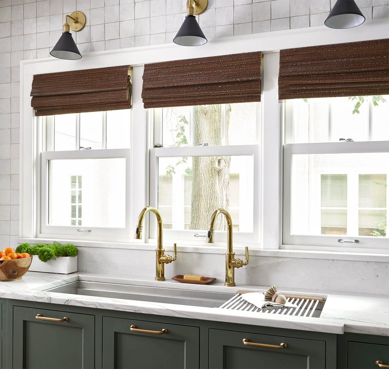 A kitchen with a sink and a lot of windows