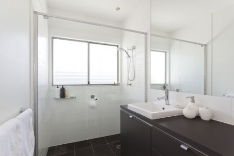 A Bathroom With A Sink, Mirror And Shower — South East Kitchens In Burleigh Heads, QLD