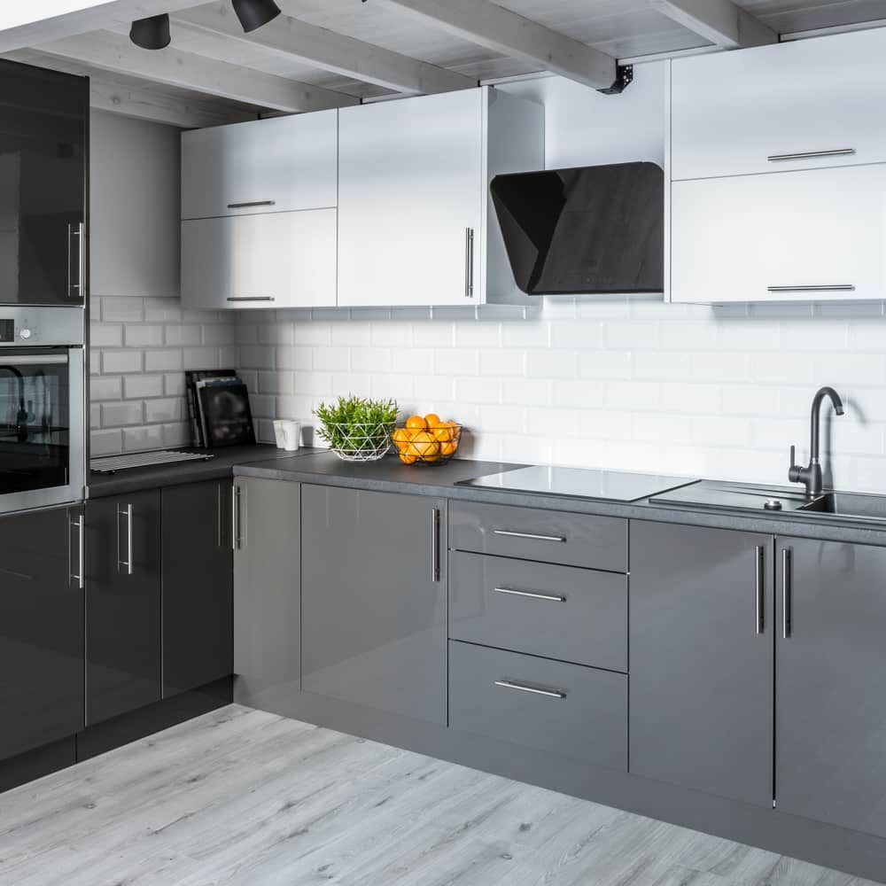 A Kitchen With Gray Cabinets, White Cabinets, A Sink, And A Stove Top Oven — South East Kitchens In Burleigh Heads, QLD
