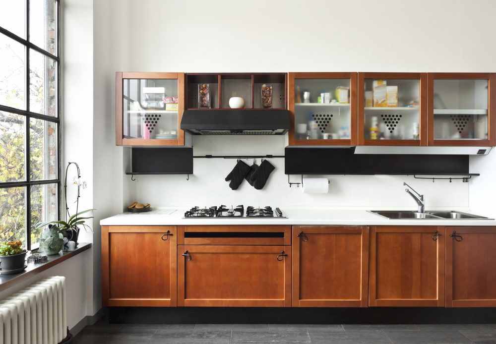 A Kitchen With Wooden Cabinets And A Stove Top Oven — South East Kitchens In Brisbane, QLD