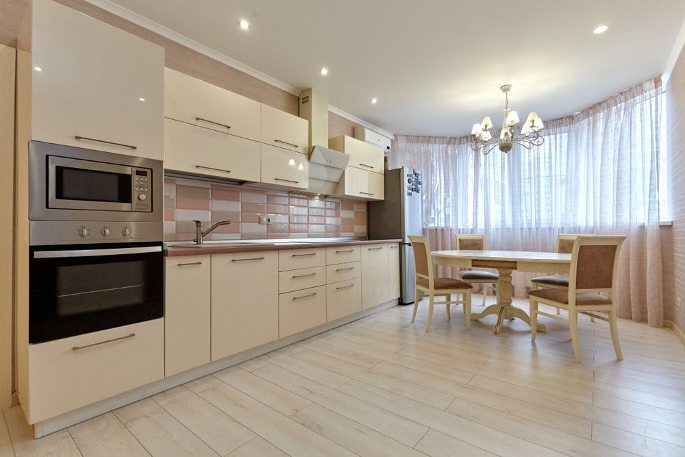 A Kitchen With White Cabinets, A Table And Chairs — South East Kitchens In Brisbane, QLD
