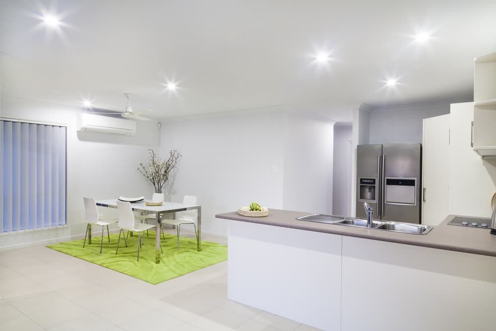 A Kitchen With A Table And Chairs And A Refrigerator — South East Kitchens In Burleigh Heads, QLD