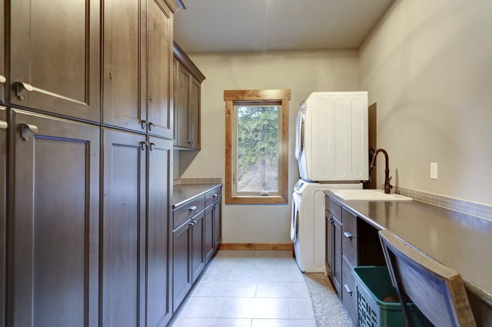A Kitchen With White Cabinets, Hardwood Floors, A Large Island And Stools — South East Kitchens In Burleigh Heads, QLD