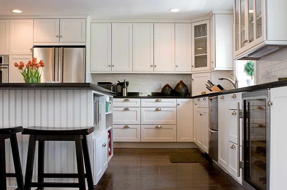A Kitchen With White Cabinets And Black Stools — South East Kitchens In Burleigh Heads, QLD