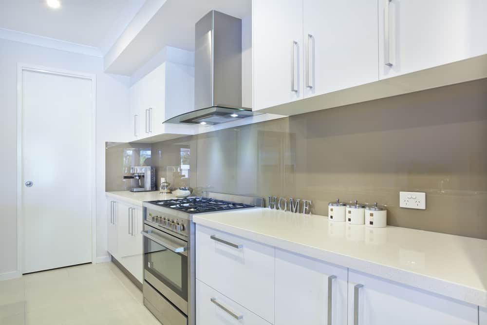 A Kitchen With White Cabinets And Stainless Steel Appliances — South East Kitchens In Burleigh Heads, QLD