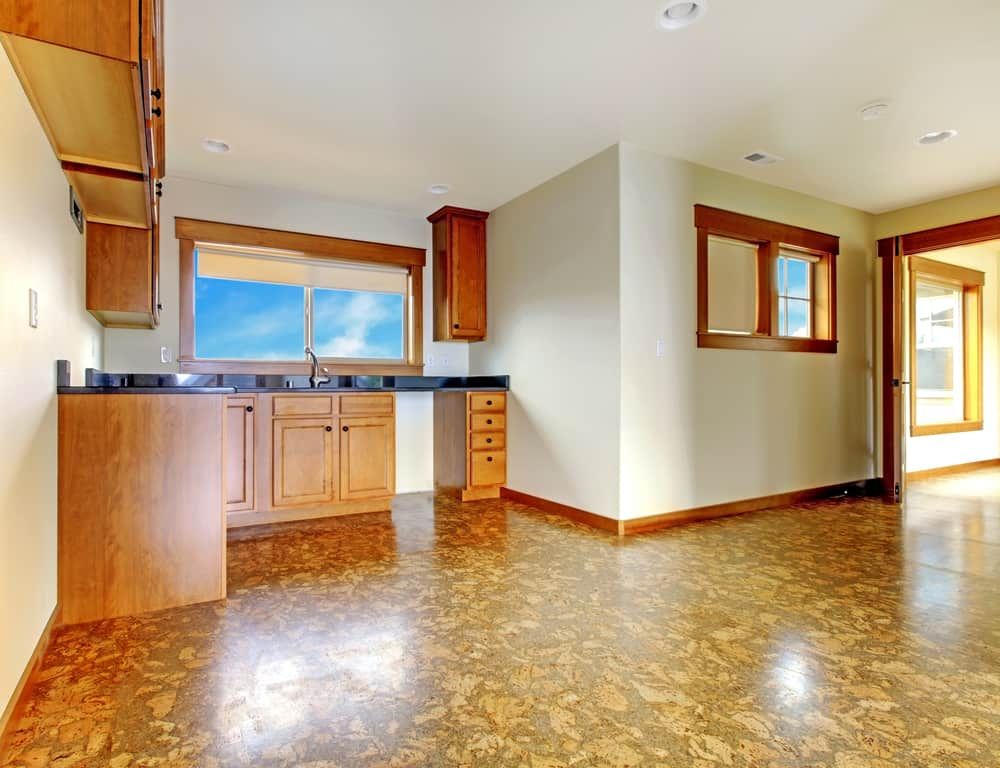 An Empty Kitchen With A Cork Floor And Wooden Cabinets — South East Kitchens In Burleigh Heads, QLD
