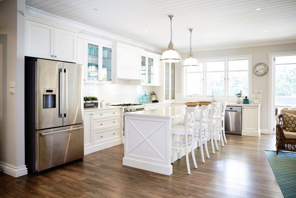 A Kitchen With White Cabinets, Stainless Steel Appliances And A Large Island — South East Kitchens In Brisbane, QLD