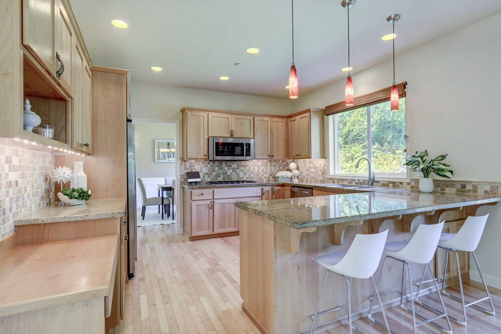 Kitchen With Cabinets, Counter Tops, Steel Appliances And A Large Island — South East Kitchens In Brisbane, QLD