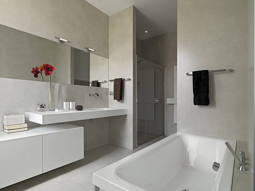 A Bathroom With A Bathtub A Sink And A Mirror — South East Kitchens In Brisbane, QLD