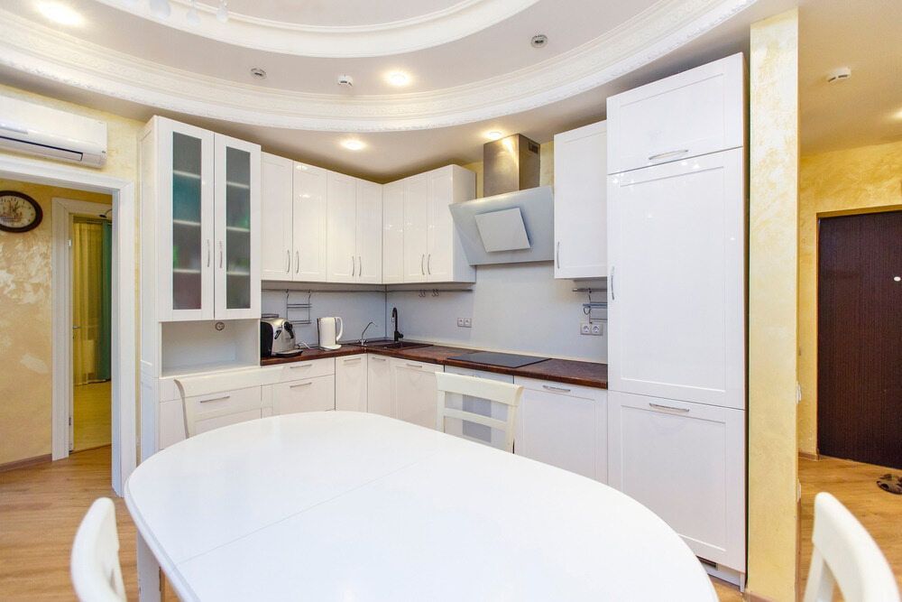 A Kitchen With White Cabinets, A Table And Chairs — South East Kitchens In Northern Rivers, NSW