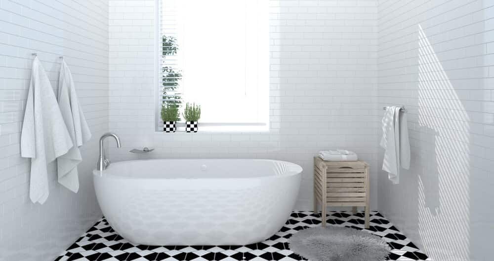 A Bathroom With A Bathtub, Sink, And Window — South East Kitchens In Gold Coast, QLD