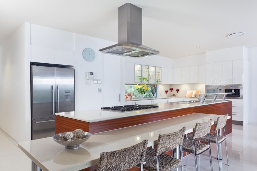 A Kitchen With White Cabinets And Stainless Steel Appliances — South East Kitchens In Burleigh Heads, QLD