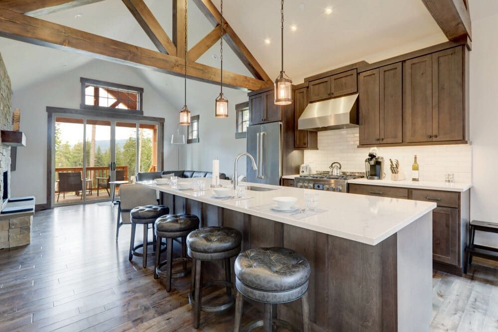 A Kitchen With A Large Island And Stools In A House — South East Kitchens In Brisbane, QLD