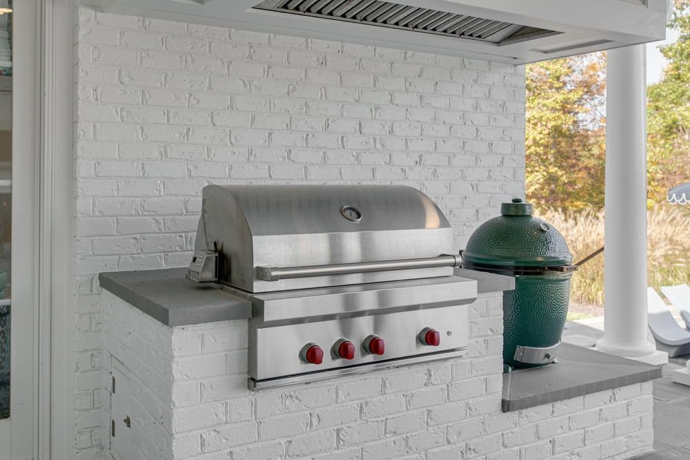 A Stainless Steel Grill Is Sitting On Top Of A White Brick Wall — South East Kitchens In Burleigh Heads, QLD
