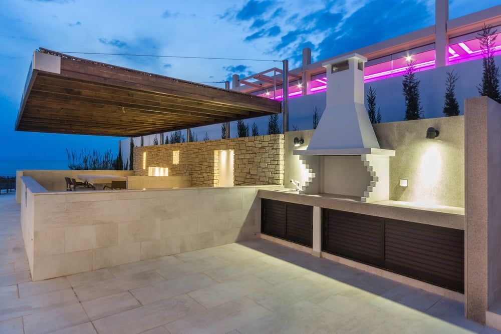 A Patio With A Grill And A Canopy At Night — South East Kitchens In Burleigh Heads, QLD