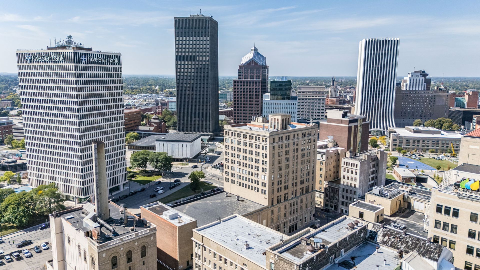 The Columbus Building exterior against Rochester skyline
