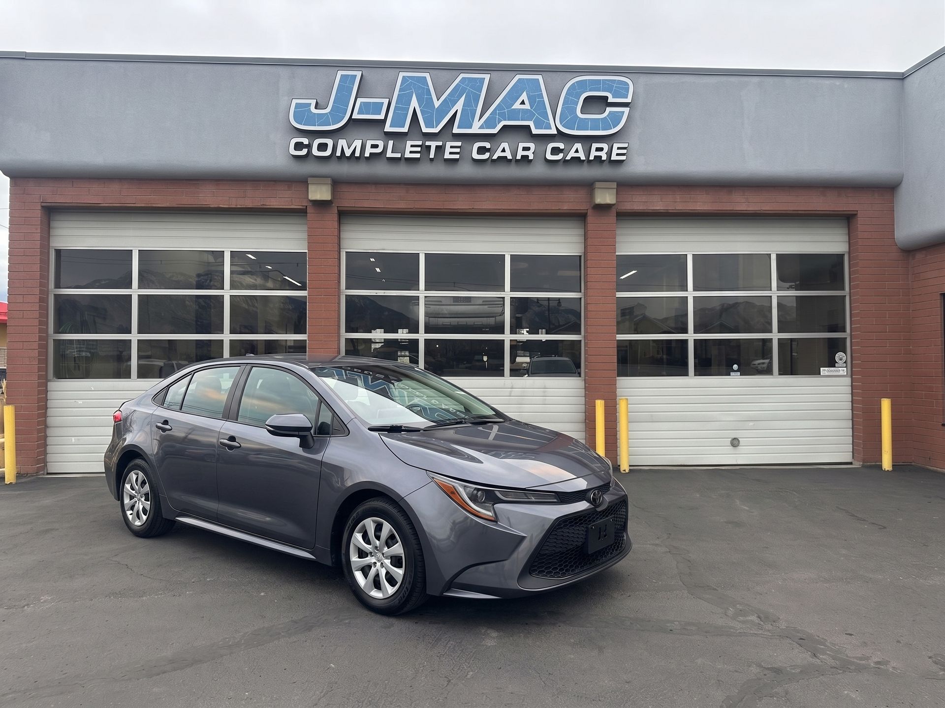 Gray sedan parked outside J-MAC Complete Car Care auto shop