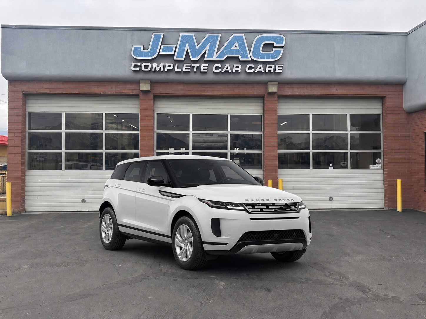 White SUV parked in front of J-Mac Complete Car Care garage storefront