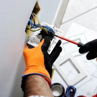 Horizon Electric USA - A person wearing orange gloves is working on an electrical box