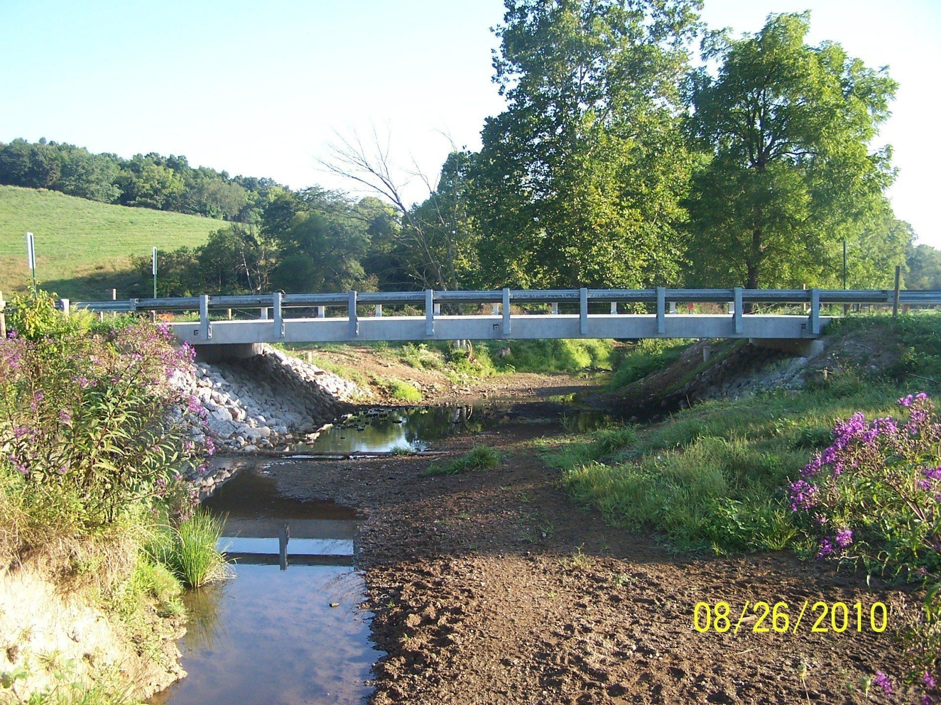 A bridge over a stream with a photo taken on 09/26/2010