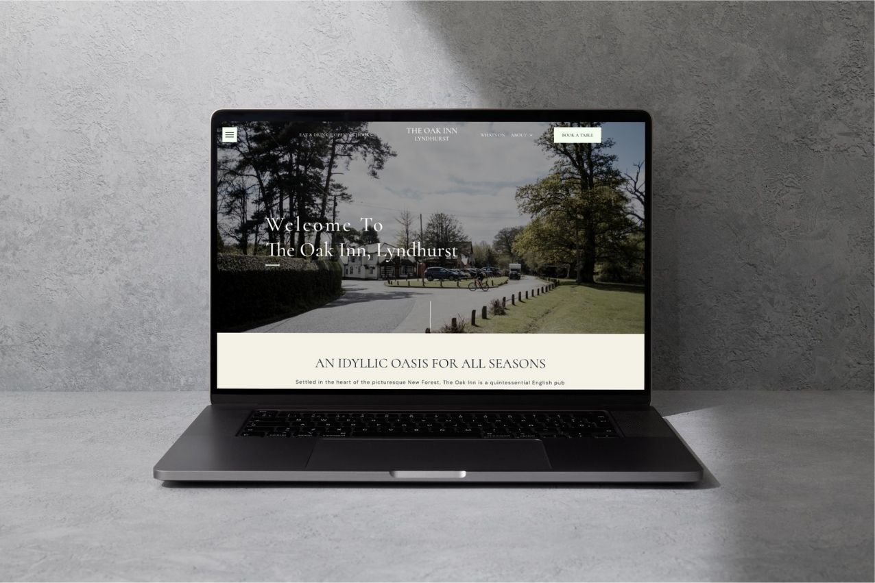 Laptop displaying a minimalist website with a park landscape hero image and navigation bar