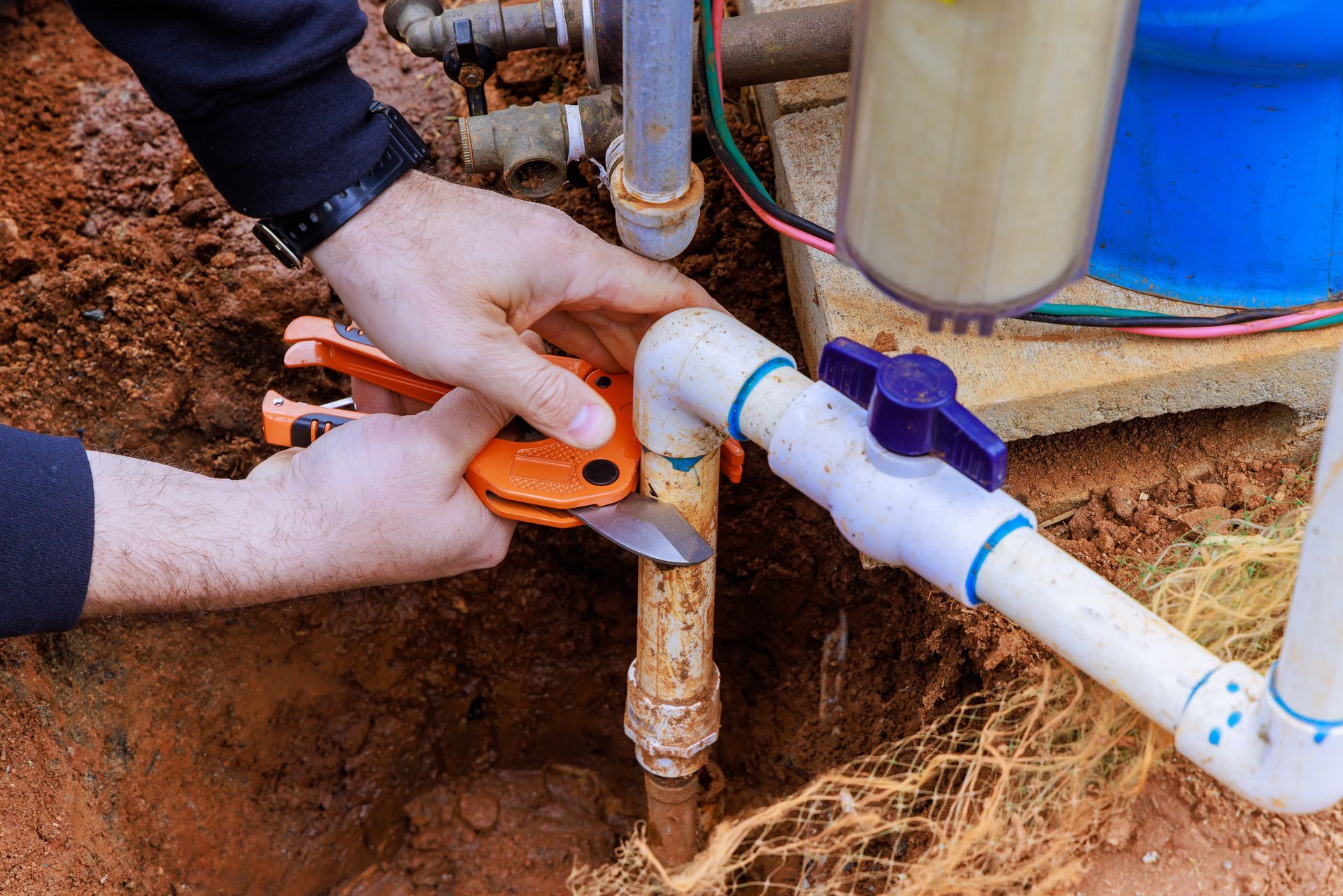 A male worker providing well water pump repair services in a private home. A male worker providing well water pump repair services in a private home.