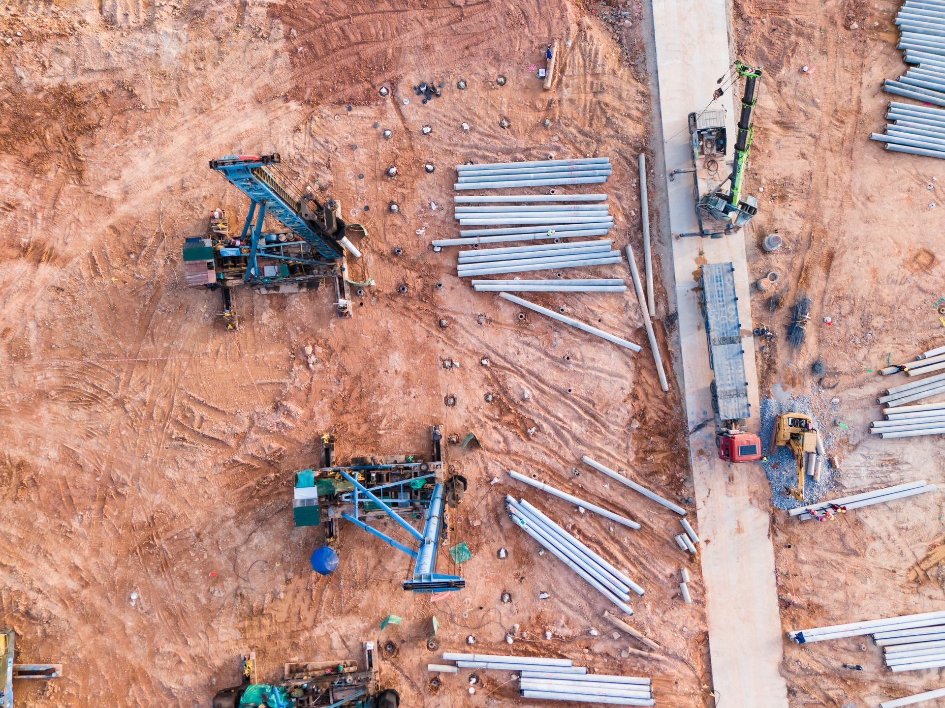 An aerial view of a construction site with a lot of machinery. An aerial view of a construction site with a lot of machinery.