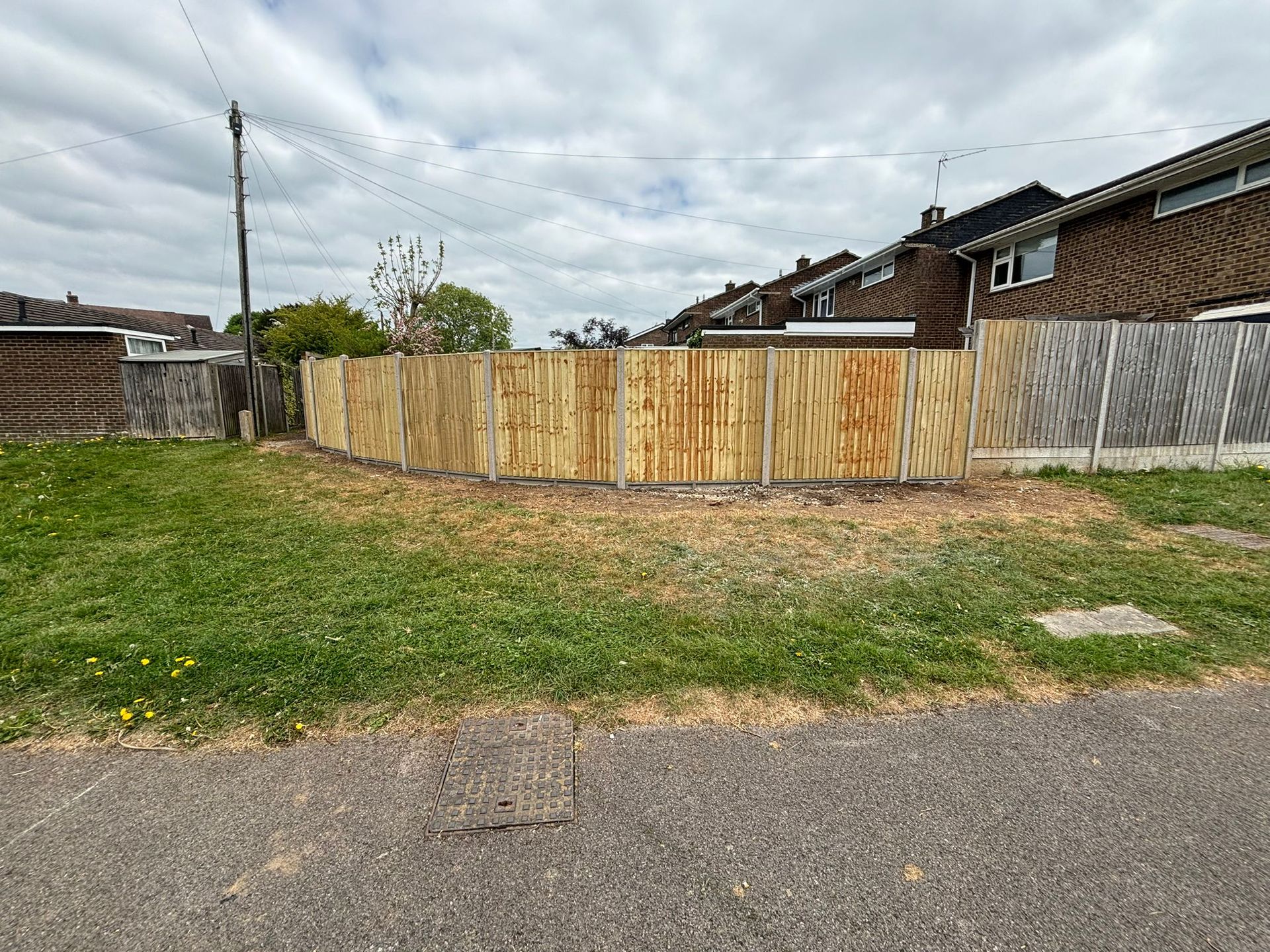 New fencing installed along line with grass and path in front