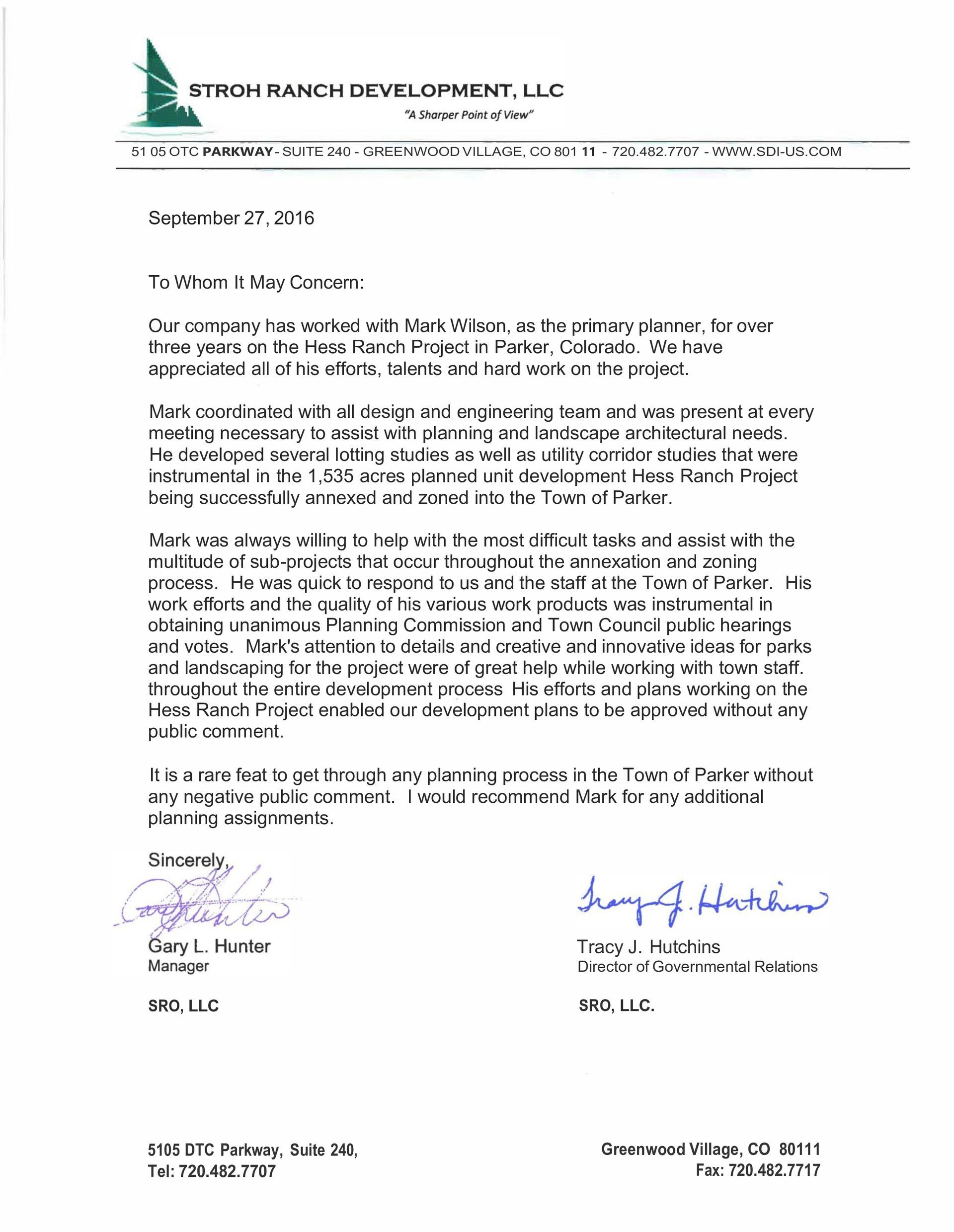 Formal business letter on company letterhead with handwritten signatures and stamp.