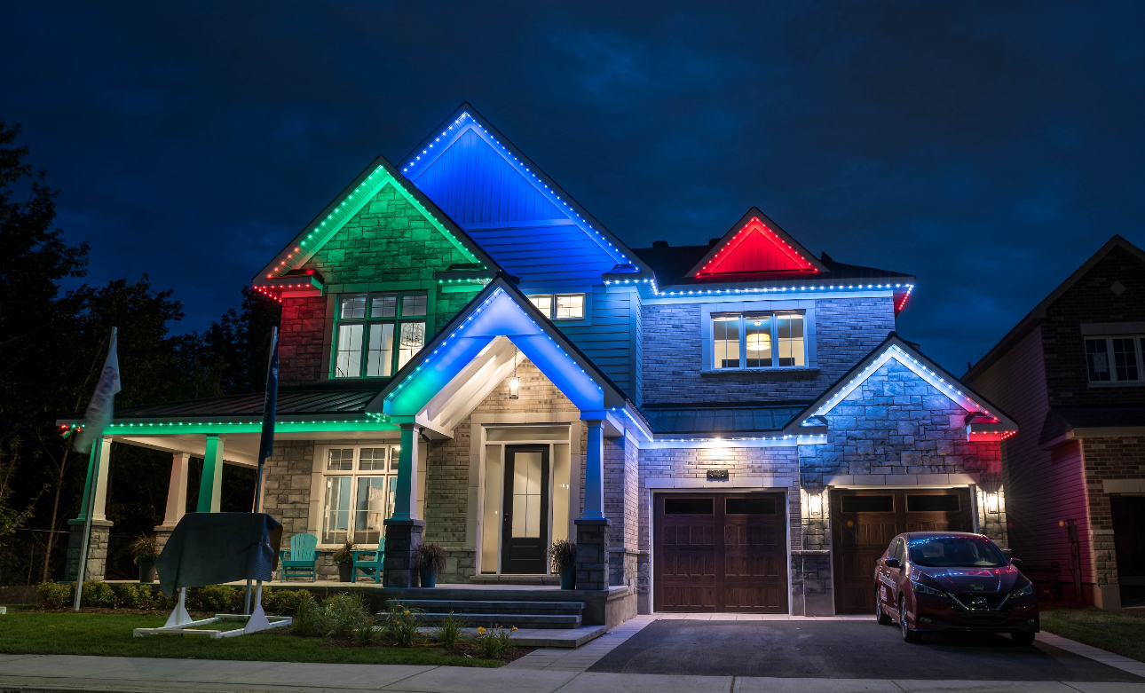 House decorated with colorful holiday lights at night.