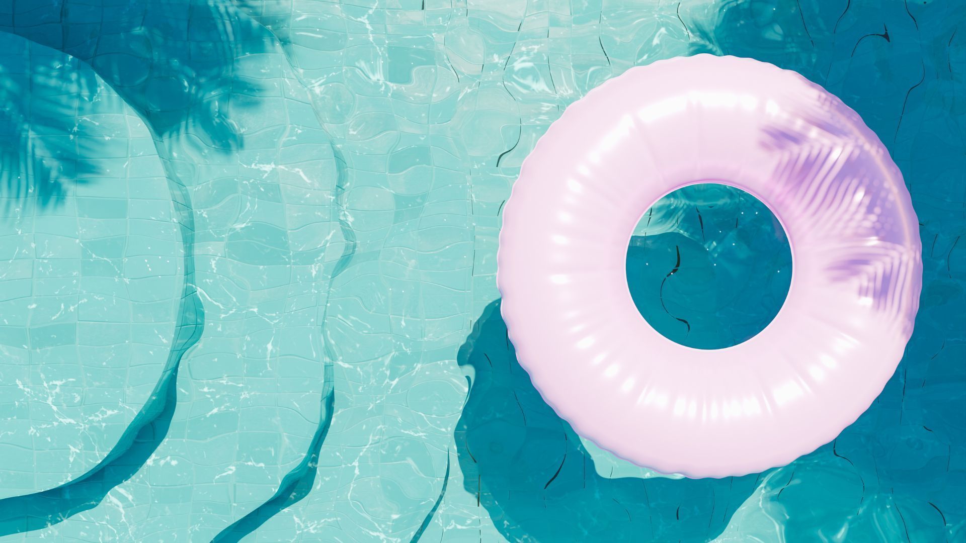 Pink inflatable swim ring floating in a turquoise swimming pool
