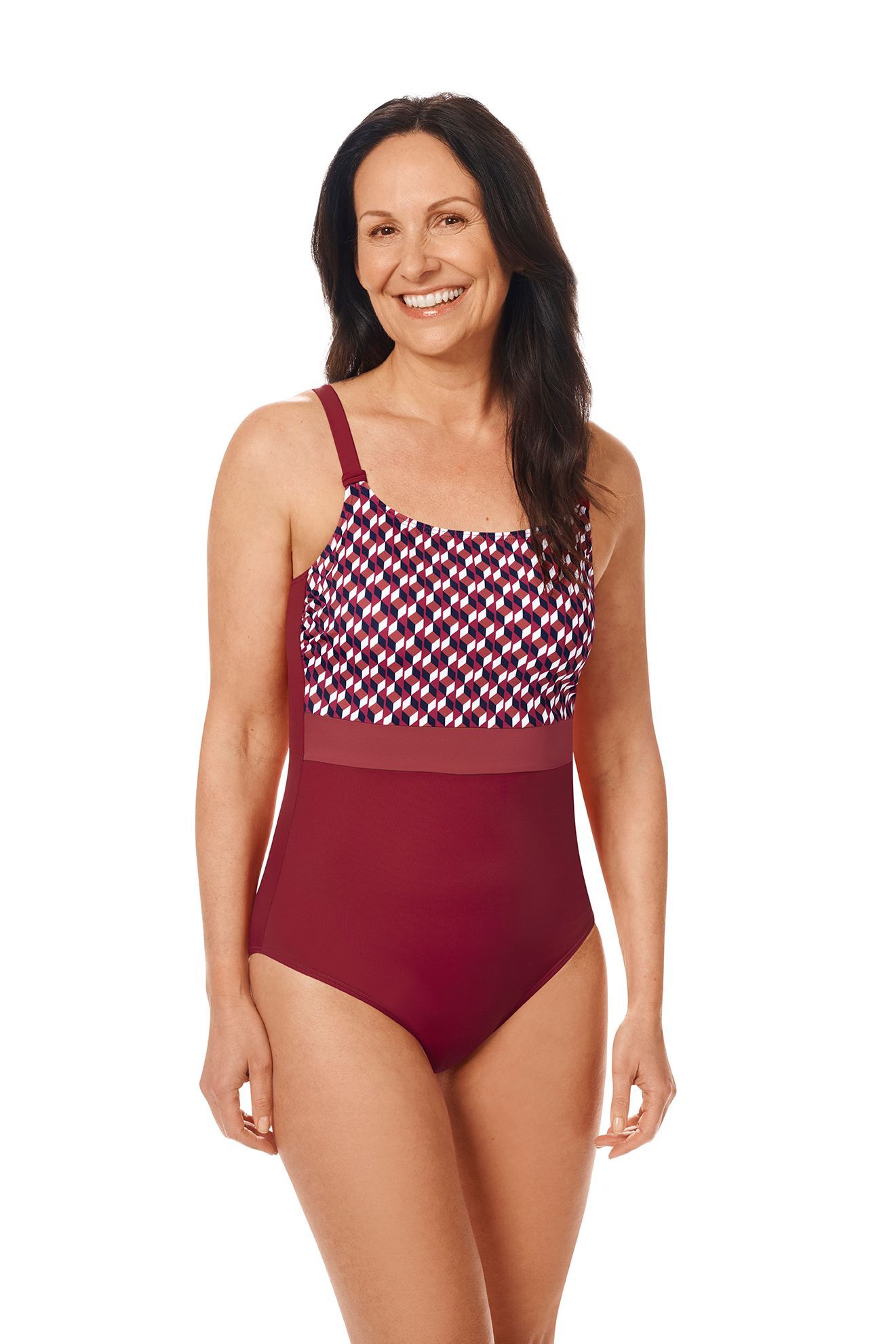 Woman in a red and patterned one-piece swimsuit, smiling, against a white background.
