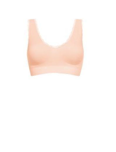 Peach-colored seamless bralette with a lace trim along the neckline.